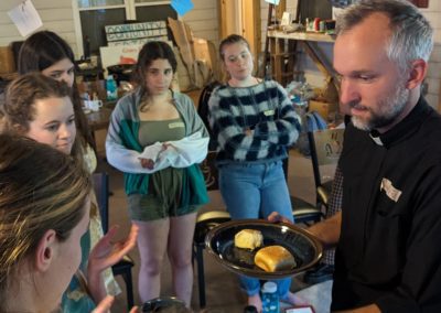 Andrew Rickel Serving Communion to Students
